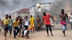 People run away during an anti-government protest, in Freetown, Sierra Leone, August 10, 2022
