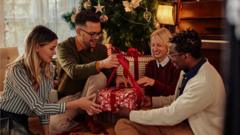 Cheerful friends opening Christmas present together