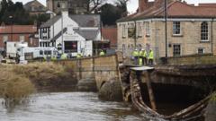 Emergency services by the collapsed bridge in Tadcaster, North Yorkshire