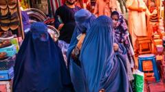 Women in Kabul market, wearing blue burqas