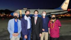 Taiwan's vice foreign minister stands in front of an aeroplane with members of the US Congress