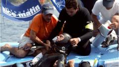 Herbert Nitsch, is helped after fainting at a depth of 107 meters during the men