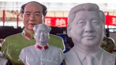 Porcelain statues of Mao Zedong and Xi Jinping on a market stall.