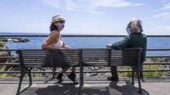 Two people sitting on park bench in Italy