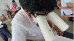 A student wears homemade goggles during a college exam in the Philippines