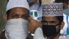 Muslim men attending prayers having temperature checked