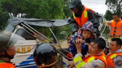 Municipal workers evacuate local people from flood water in Quang Tri province, Vietnam, on 18 October 2020