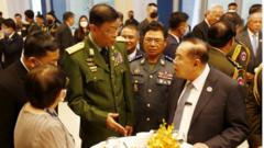 Myanmar Union Minister of Defence, General Mya Tun Oo (C) talks with Thailand"s Deputy Defence Miniter Prawit Wongsuwan (R-C)