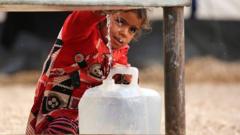 A girl getting water from a tank