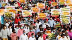 Sri Lankan supporters of the opposition People's Liberation Front (JVP) shout slogans during a protest against the agreement with India to develop the Trincomalee oil tank farm project, in Colombo on January 19, 2022.