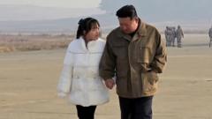 North Korea's leader Kim Jong-un is seen standing hand-in-hand with his daughter in this photo released by KCNA news agency