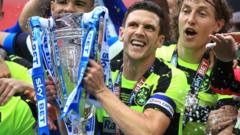 Huddersfield's Mark Hudson celebrates with the trophy