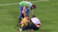 Ergotelis’ Leonardo Koutris is dropped to the floor by two stretcher-bearers