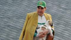 Turkmenistan's President Gurbanguly Berdymukhamedov holds a Turkmen shepherd dog