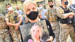 Woman holds picture of person killed in Beirut port explosion (file photo)