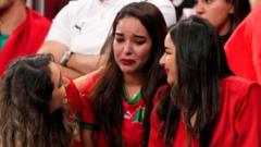 Moroccan fans comfort each other at the stadium in Qatar