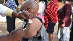 A Kenyan medic gives a dose of the AstraZeneca Covid-19 vaccine, during a mass vaccination drive at the Dandora Health center in the Nairobi's informal settlement on August 10, 2021
