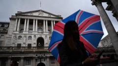 A person holds an umbrella with a Union Jack print outside the Bank of England in London, Britain, 03 November 2022