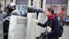 A woman addresses a Belarusian law enforcement officer during an opposition rally to protest against police brutality and to reject the presidential election results in Minsk, Belarus, 6 September