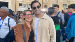 A couple of Juan and Carla from Barcelona hug on St. Peter's Square to see the election of the new pope.