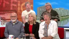 Five smartly dressed people sitting on the BBC Breakfast sofas