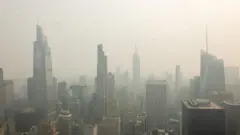 The New York City skyline is seen with a thick haze of smoke