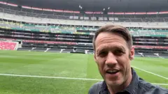 Will Grant takes a photo looking into his phone camera inside Mexico City’s Azteca Stadium.