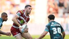 Wigan go top after surviving Huddersfield scare