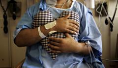 Ashok Verma holds a heart-shaped pillow to his chest as the light pressure helps a