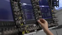 We see an astronaut training in a mission simulator.