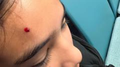 Girl injured after £1 coin thrown at football match