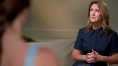 Victoria Derbyshire interviewing a teenage girl, seen from over her shoulder and out of focus