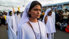 Demonstrators participate in an act to condemn the 2019 Easter Sunday suicide bombings at three churches and three deluxe hotels, killing almost three hundred people, on the eve of the third anniversary of the attacks in Colombo on April 20, 2022