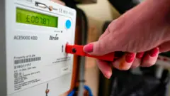 What's happening with gas and electricity prices? 21 Getty Images Hand on a key being inserted into a prepayment meter with a display showing £7.87 left in credit.
