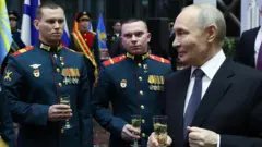 Alexander Kazakov/Pool/AFP A man holding a glass stands to the right of two men in uniform