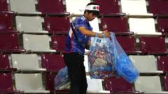 A Japanese fan clears rubbish from the stands during the FIFA World Cup Qatar 2022 Group E match between Germany and Japan at Khalifa International Stadium on November 23, 2022 in Doha, Qatar. 