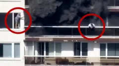 A man leaning out of a balcony, with a red circle around him, while black smoke can be seen, and another gesturing out a window to the left, both are overlain with red circles to make them out