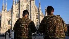 Piero Cruciati/AFP Italian troops stand guard outside a cathedral in Milan