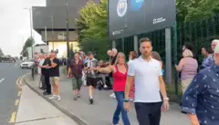 Fans streaming out of the Co Op Live arena in Manchester. They are walking up the road close to the venue.