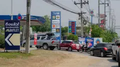 Long queues of vehicles line the road in Mae Sot, west Thailand waiting for fuel amid ongoing supply concerns. Residents in Mae Sot are rushing to buy fuel due to worries about potential shortages and price increases from the conflict in the Middle East.