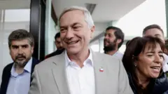 Jose Antonio Kast, presidential candidate of the far-right Republican Party of Chile, and his wife Maria Pia Adriasola Barroilhet, arrive at a polling station to vote during a presidential runoff election