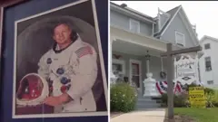 On the left, a framed photo of Neil Armstrong; on the right, a house for sale.