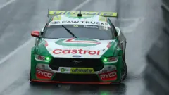 Getty Images A green Ford racing car with a Castrol sponsorship logo on the bonnet.