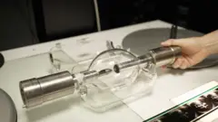 A huge lightbulb with silver handles either side