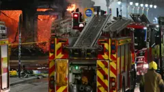 Floors collapse inside the building as fire fighters work at the site of a large fire in Glasgow City centre on March 8, 2026.