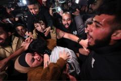 A Palestinian man hugs a family member after being released as part of the deal between Israel and Hamas, in the West Bank city of Ramallah, 26 November 2023