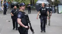 Police officers stand guard at a site near Seattle Center.