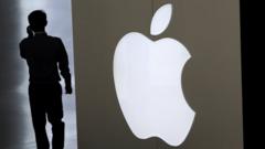Man walks past Apple logo.