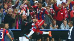 Jerome Boateng of Bayern Muenchen jumps for joy
