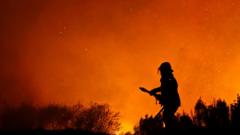A fire fighter fights a fire on the lower part of Table Mountain near a residential area in Cape Town, South Africa, Monday, Feb. 16, 2015. The wildfire broke out near to Cape Town"s central business district.